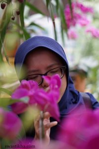 woman with orchid plant